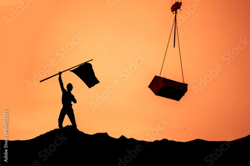 Silhouette of the businessman,success had been difficult. on the surface above the sky and the sun light,examples of success