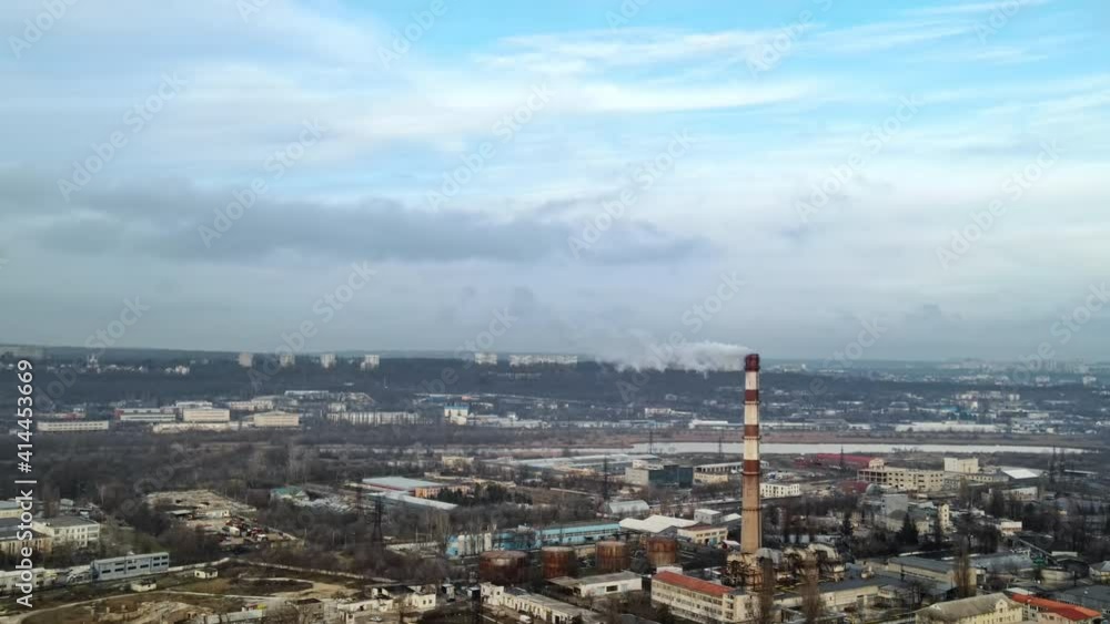 Aerial drone view of Chisinau. Thermal station with smoke coming out of the tube. Buildings, roads and bare trees. Cloudy weather. Moldova Aerial drone view of Chisinau. Thermal station with smoke coming out of the tube. Buildings, roads and bare trees. Cloudy weather. Moldova