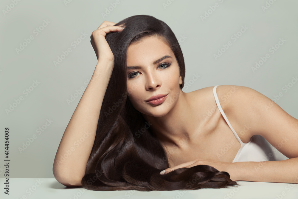Stylish woman with long hair on white background. Haircare and skin care concept Stylish woman with long hair on white background. Haircare and skin care concept