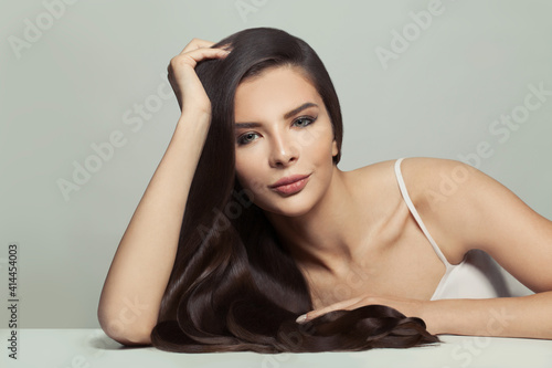 Stylish woman with long hair on white background. Haircare and skin care concept