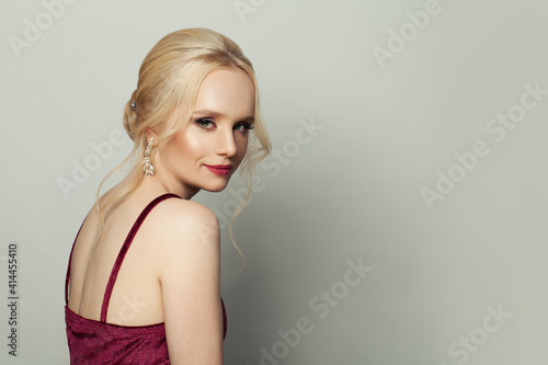 Young pretty blonde woman smiling on white background