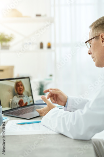 Doctor talking with patient through video call in clinic