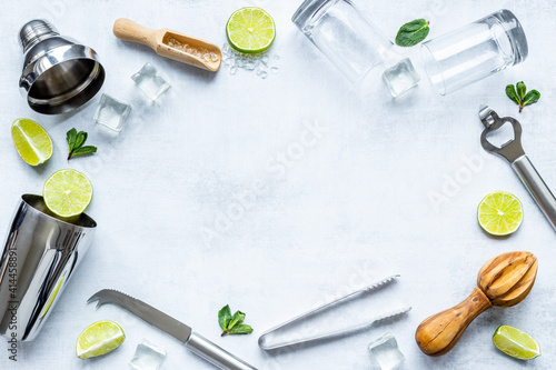 Frame of bar utensils and tools for Mojito cocktail - shaker, lime and ice