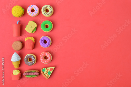 Top view of rubber food toys isolated on a red background.