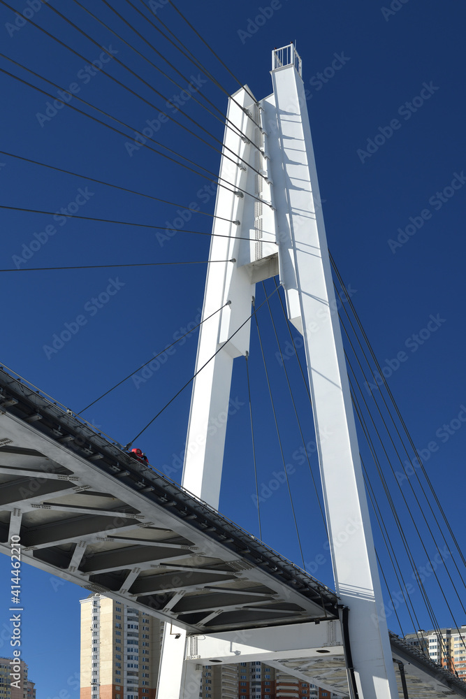 Urban landscape. Pedestrian bridge from two pylons, each measuring 41 m tall. Pylons are connected to spans with help of 28 straight cable wires Urban landscape. Pedestrian bridge from two pylons, each measuring 41 m tall. Pylons are connected to spans with help of 28 straight cable wires