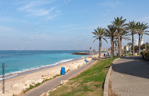 A few tourists and residents of the city walk along the embankment against the backdrop of the Mediterranean Sea in Haifa city  in northern Israel.