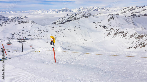 Beautiful and serene landscape of mountains covered with snow in Moelltaler Gletscher, Austria. Thick snow covers the slopes. Clear weather. Perfectly groomed slopes. Massive ski resort. photo