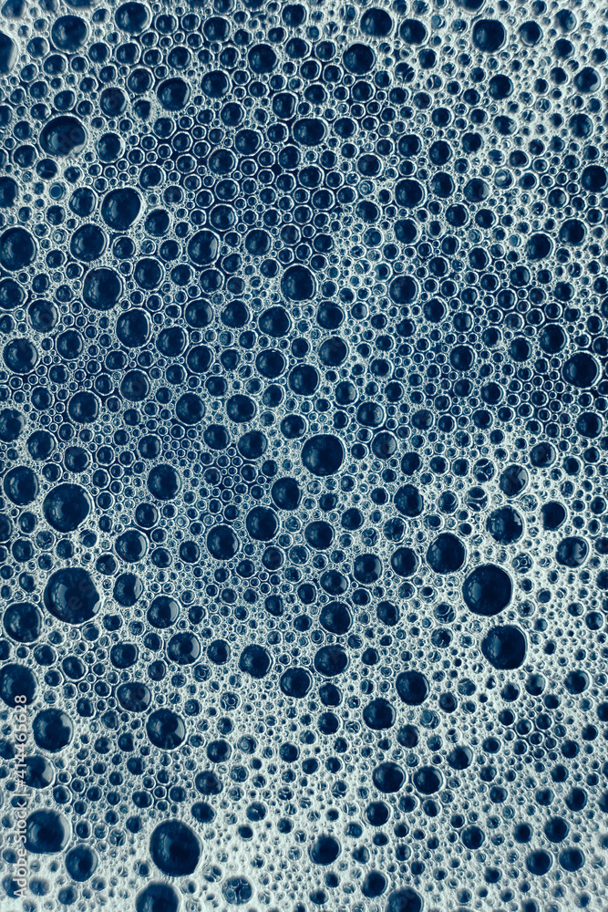 Soap bubbles on a background of blue water as a texture. Top view. Copy, empty space for text Soap bubbles on a background of blue water as a texture. Top view. Copy, empty space for text