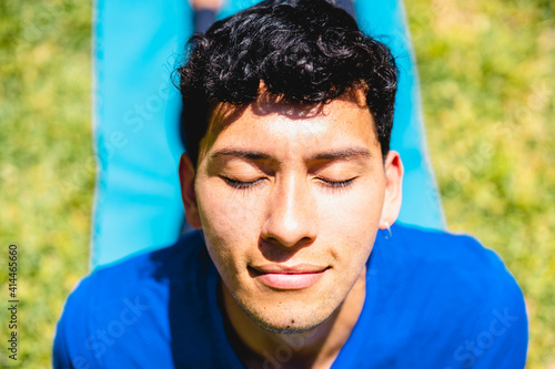 PORTRAIT RELAXED MAN DOING EXERCISE YOGA ON NATURE OUTDOOR