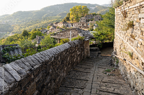 Fototapeta Naklejka Na Ścianę i Meble -  Stone houses of traditional architecture and cobble-stone narrow street in Mikro Papigo in Epirus, Greece