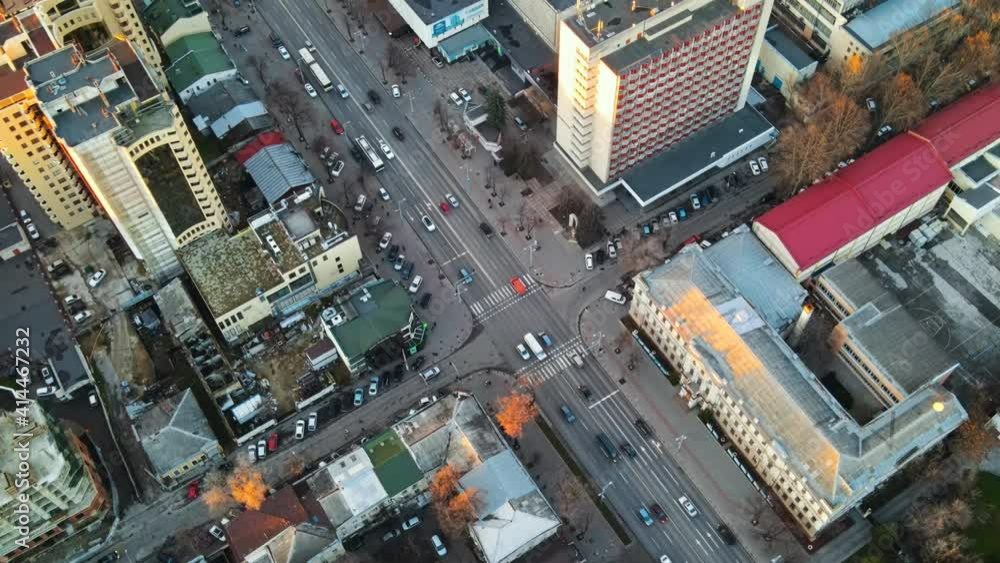 Aerial drone view of Chisinau at sunset. View of multiple buildings, street with moving cars, bare trees. Moldova Aerial drone view of Chisinau at sunset. View of multiple buildings, street with moving cars, bare trees. Moldova