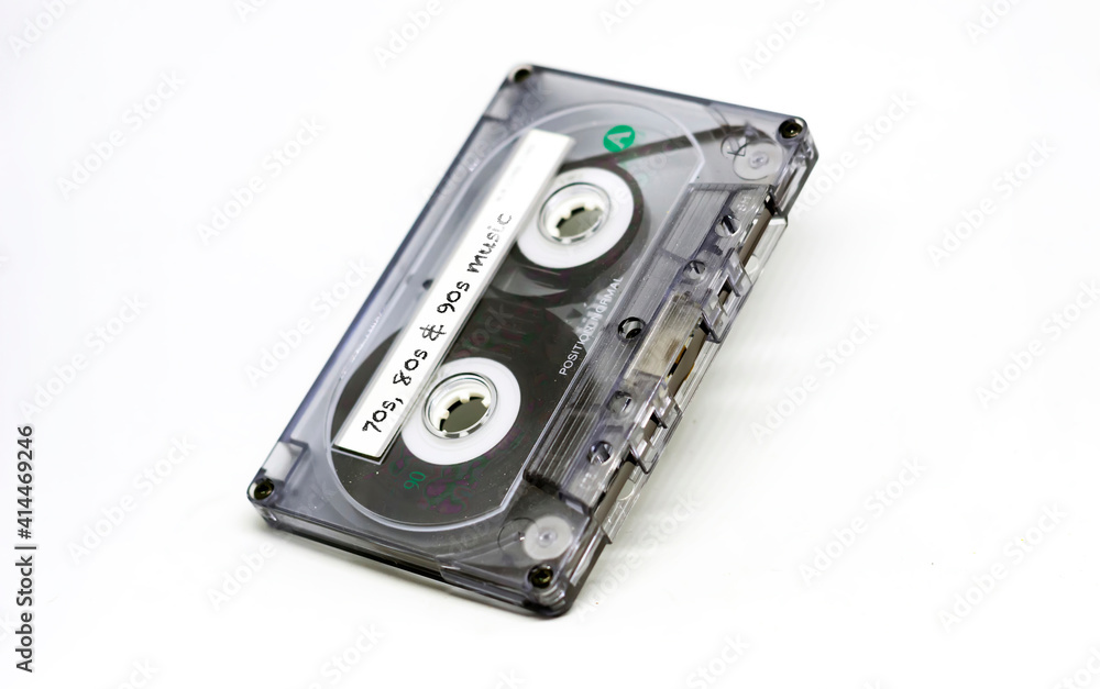 transparent audio cassette with music from the 70s, 80s and 90s written on the adhesive label. Outdated technology transparent audio cassette with music from the 70s, 80s and 90s written on the adhesive label. Outdated technology