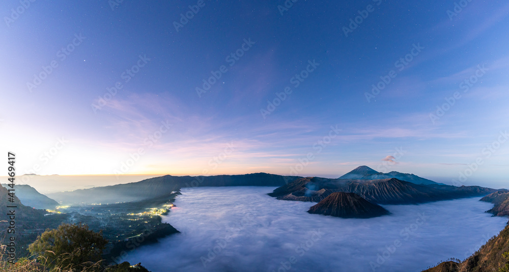 Panorama view of Mount Bromo volcano at sunrise in East Java, Indonesia surrounded by morning fog by morning fog.