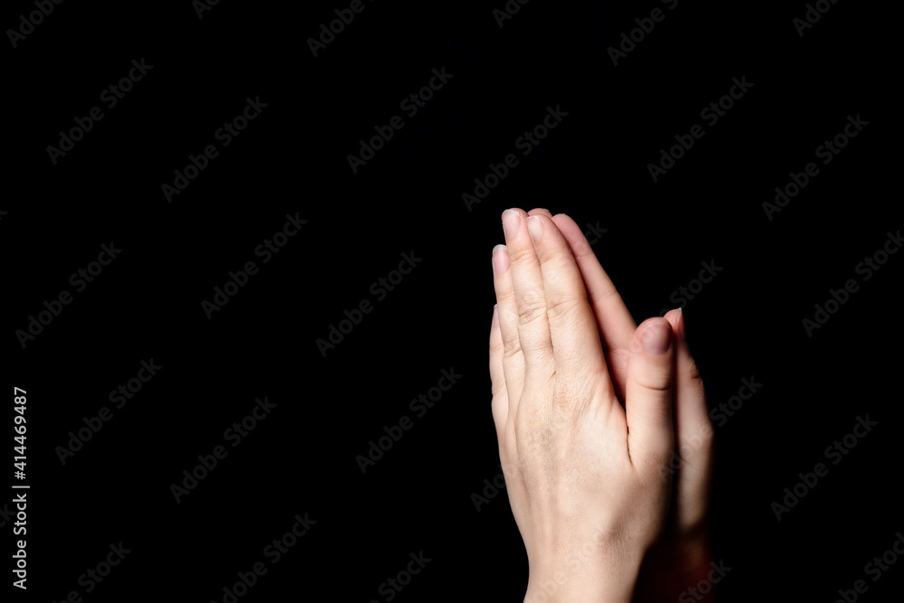 Praying hands with faith in religion and belief in God on blessing background. Power of hope or love and devotion in the dark with copy space Praying hands with faith in religion and belief in God on blessing background. Power of hope or love and devotion in the dark with copy space