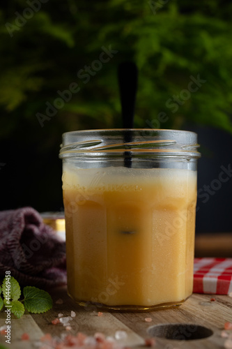 Homemade salted caramel in jam jar, butter cream sauce