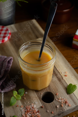 Homemade salted caramel in jam jar, butter cream sauce