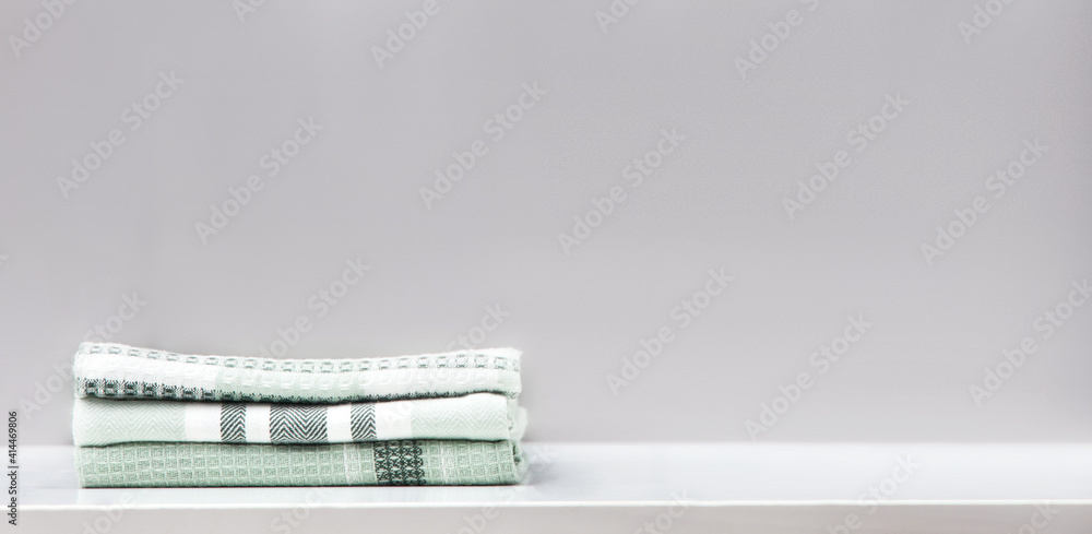 Stack of cotton kitchen towels on table