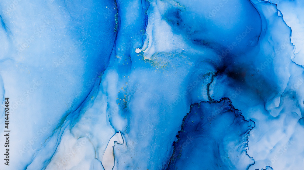 Blue alcohol stains of paint with the addition of gold powder. Subtle waves of paint, abstract blue waves of the ocean, lines of marble. Liquid paints, gradient stains, painting. Blue alcohol stains of paint with the addition of gold powder. Subtle waves of paint, abstract blue waves of the ocean, lines of marble. Liquid paints, gradient stains, painting.