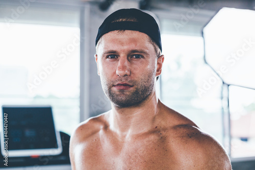 Portrait handsome and confident Caucasian man at gym. Face of brutal muscular sexy male. He's sweating after fitness workout. healthy and lifestyle athletic people.