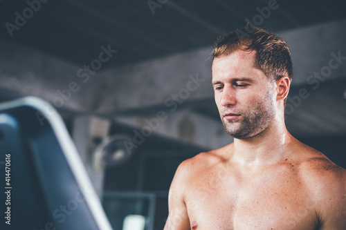Portrait of Caucasian athletic topless man running workout on treadmill. side view of muscular men do fitness endurance exercise training at gym. healthy and lifestyle concept. copy space