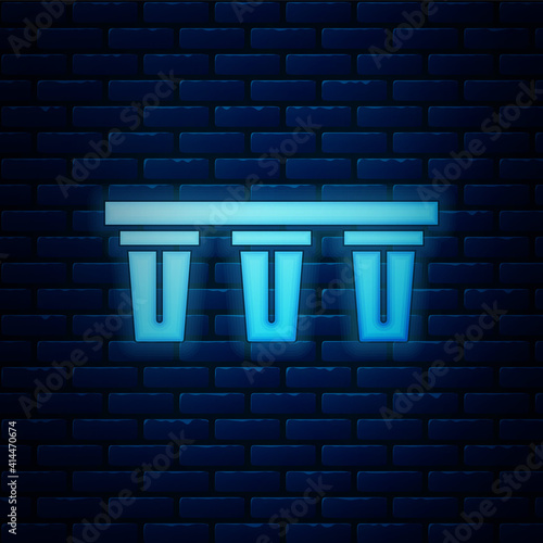 Glowing neon Water filter icon isolated on brick wall background. System for filtration of water. Reverse osmosis system. Vector.