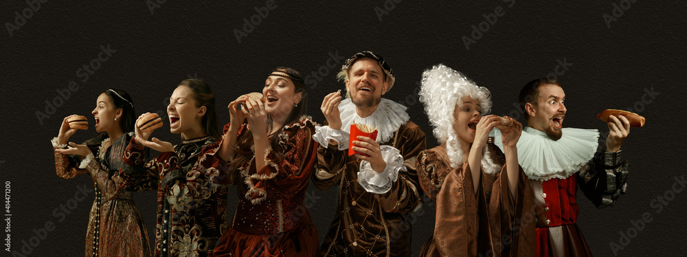 Favorite fast food tastes. Medieval people as a royalty persons in vintage clothing on dark background. Concept of comparison of eras, modernity and renaissance, baroque style. Creative collage.