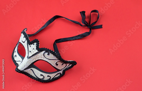 masquerade mask on a red background photo