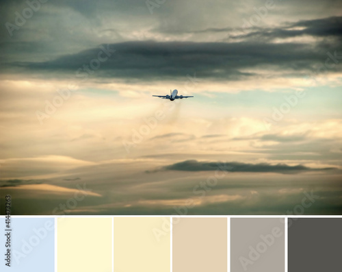 Color palette swatches of dramatic dark grey and bright orange clouds in the sky at sunset, a small silhouette of airplane. Pastel trendy warm combination, colorful inspiration from natural beauty.