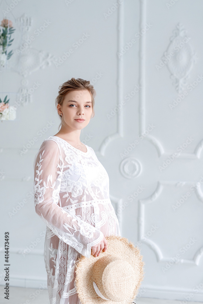 Obraz premium portrait of a pregnant woman in a white dress
