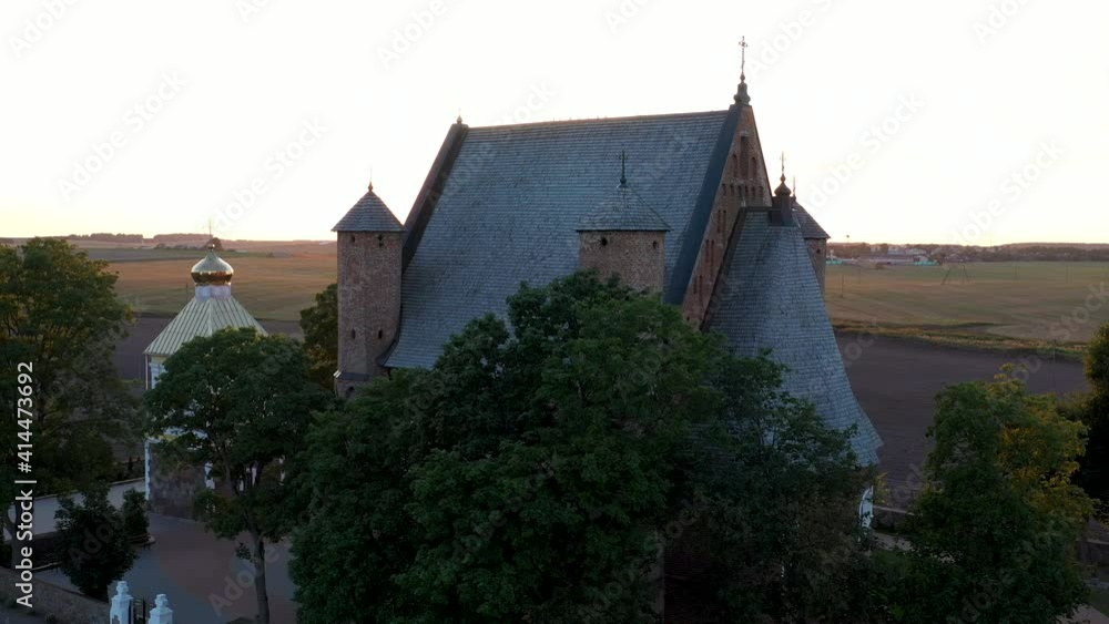 Aerial drone view. A majestic Orthodox church in the village of Synkovichi, Belarus. View from a drone to the Church of St. Michael at sunset. Aerial drone view. A majestic Orthodox church in the village of Synkovichi, Belarus. View from a drone to the Church of St. Michael at sunset.