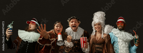 Party, hanging out, cheers. Medieval people as a royalty persons in vintage clothing on dark background. Concept of comparison of eras, modernity and renaissance, baroque style. Creative collage. photo