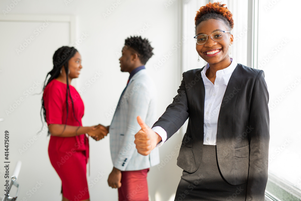 team of young african people in office with hand gesture 