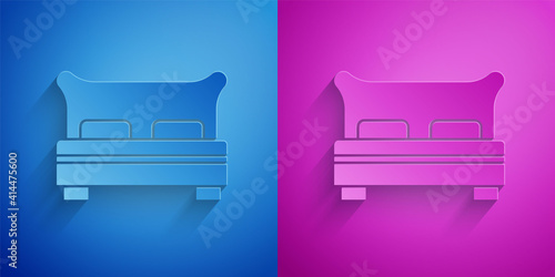 Paper cut Big bed for two or one person icon isolated on blue and purple background. Paper art style. Vector.
