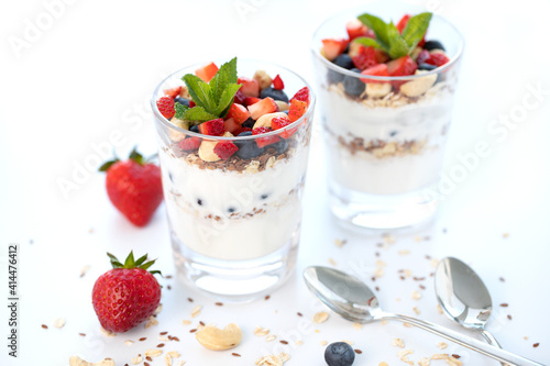 Wallpaper Mural Two glasses of strawberry parfait made with fresh fruit, yogurt, blueberries, flax seeds and muesli, white background. Healthy Eating Concept Torontodigital.ca