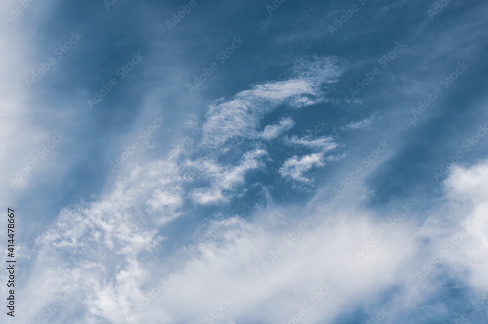 Reflections warm rays setting sun, swirls strong gust wind, outdoors. Bright blue sky, white translucent feathery clouds. Horizontal photography Reflections warm rays setting sun, swirls strong gust wind, outdoors. Bright blue sky, white translucent feathery clouds. Horizontal photography