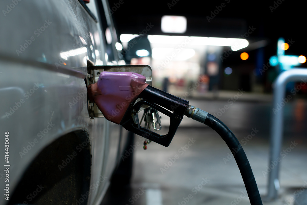 Refill gas car At a service station at night Bokeh lights on the background Refill gas car At a service station at night Bokeh lights on the background