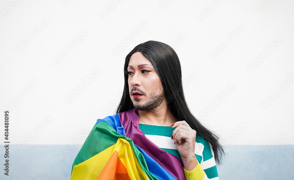 Drag queen or transgender person at gay pride parade with lgbt rainbow ...