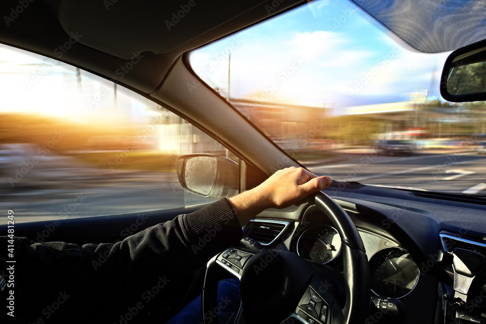 Fototapeta premium driving fast a car down the street