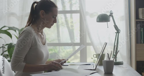 Young businesswoman working from home with her laptop