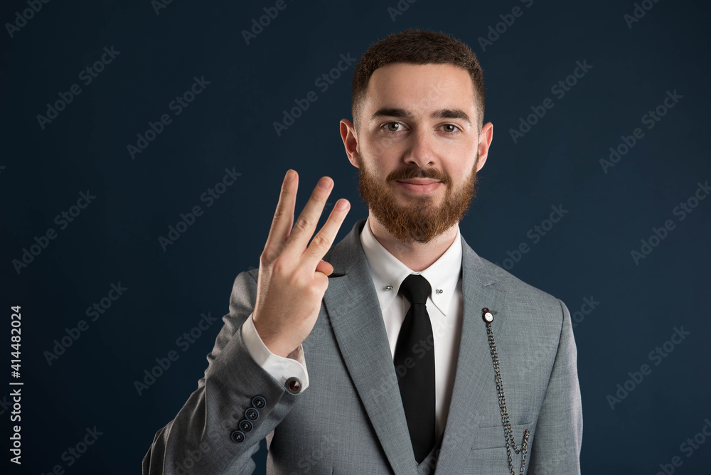 Happy businessman showing the number three Happy businessman showing the number three