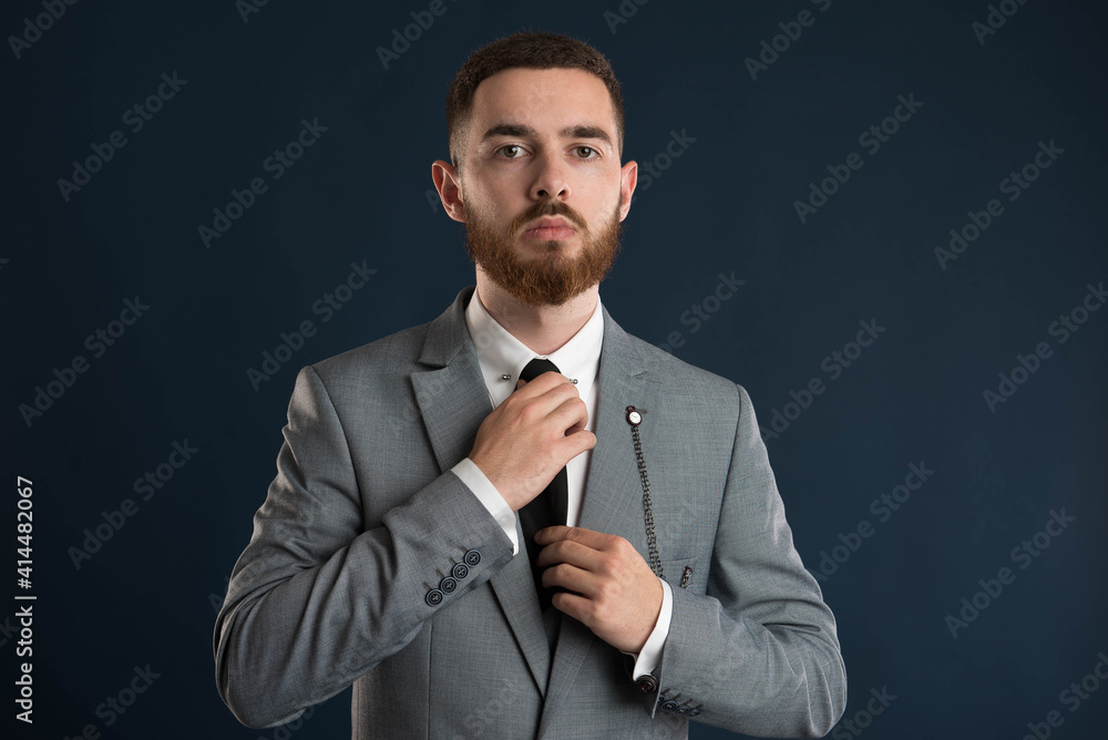 Handsome businessman fixing his black tie Handsome businessman fixing his black tie