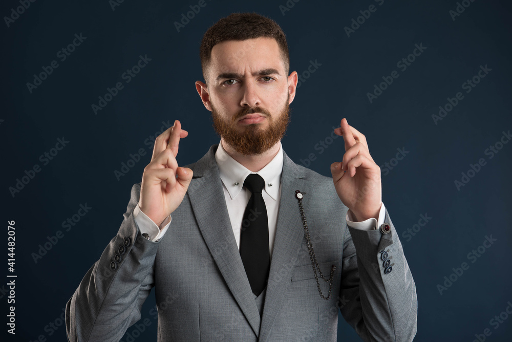 Young handsome businessman showing bad luck sign Young handsome businessman showing bad luck sign
