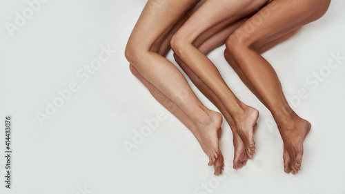 Photos Folded legs of three ladies lying on the ground