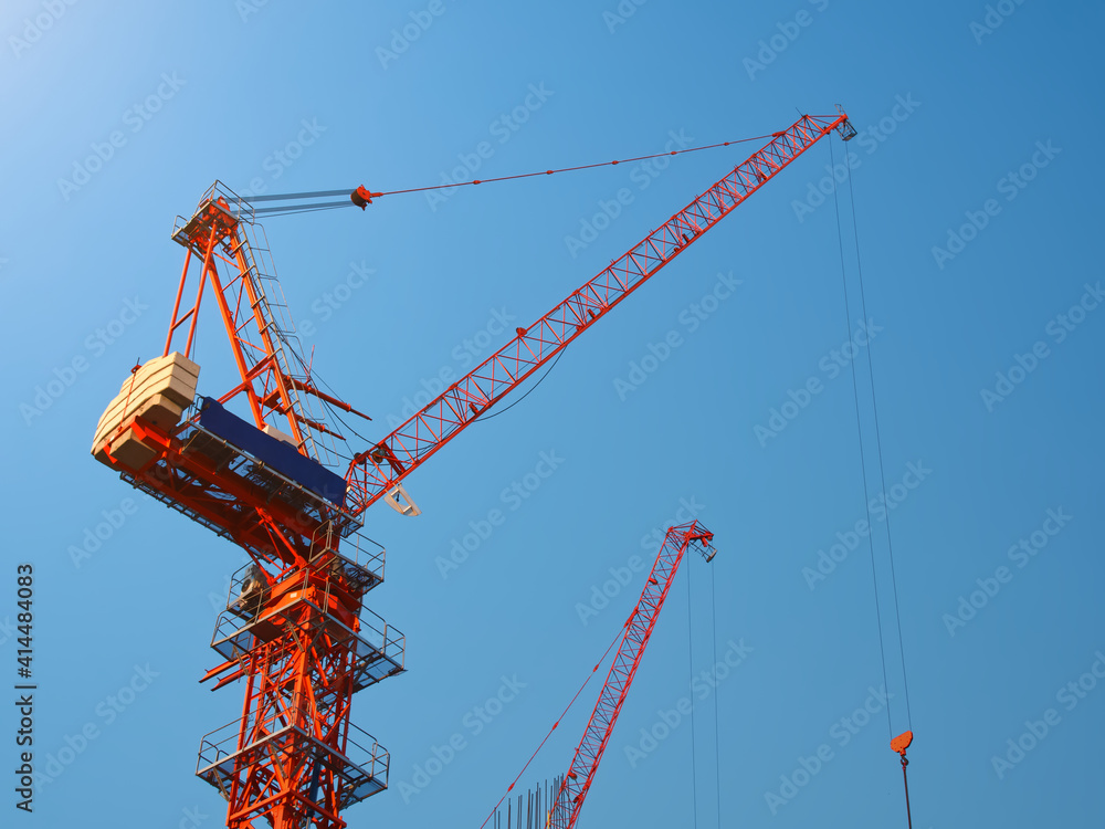 Crane on construction site, Outdoor working with backdrop of blue sky and sunrise morning. Crane on construction site, Outdoor working with backdrop of blue sky and sunrise morning.
