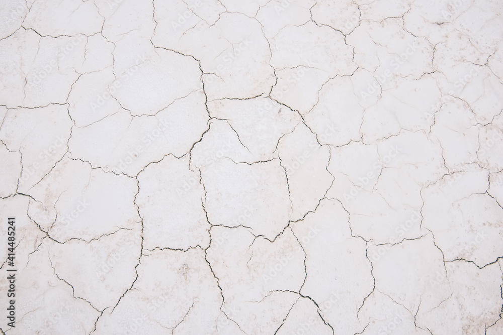 Damaged cracks on white sandy surface Damaged cracks on white sandy surface