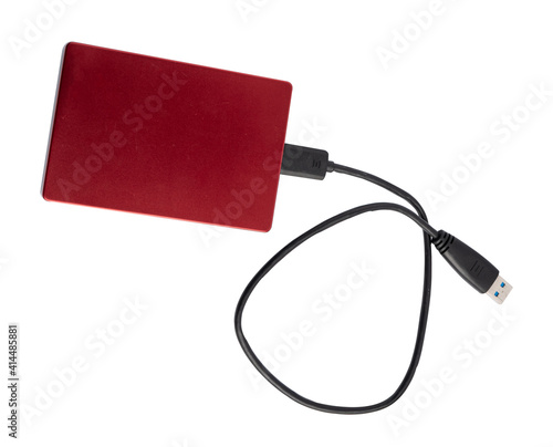 Red external hard disk storage backup drive for computer isolated on white background.