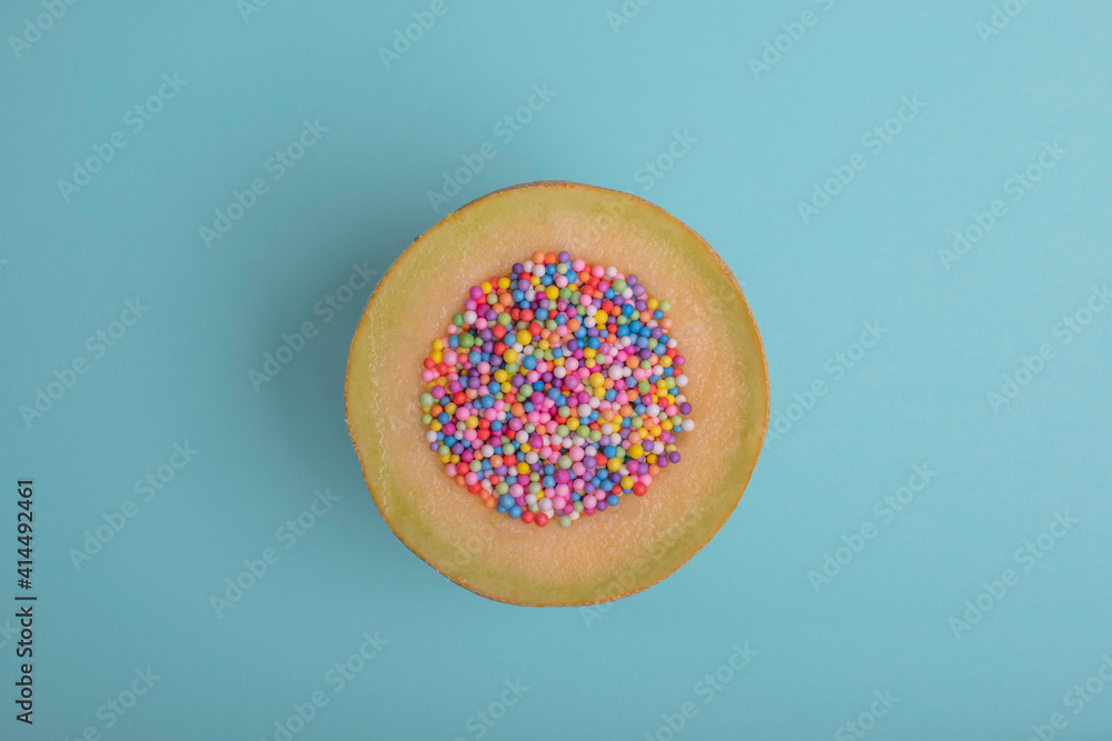 Color balls in melon on blue background. concept simple art Color balls in melon on blue background. concept simple art