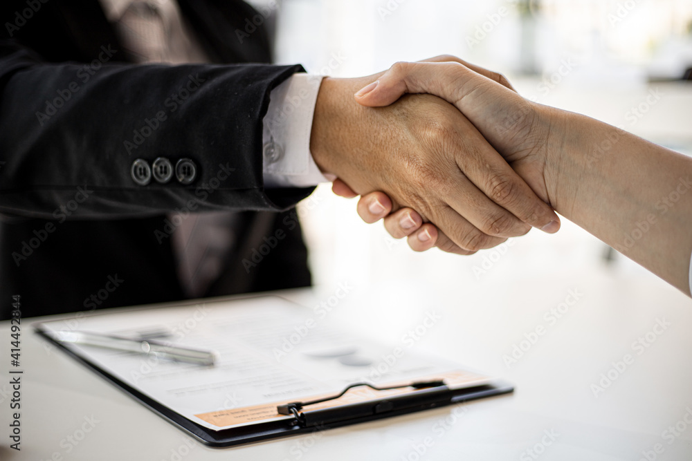 Managers and job applicants are handshaking.