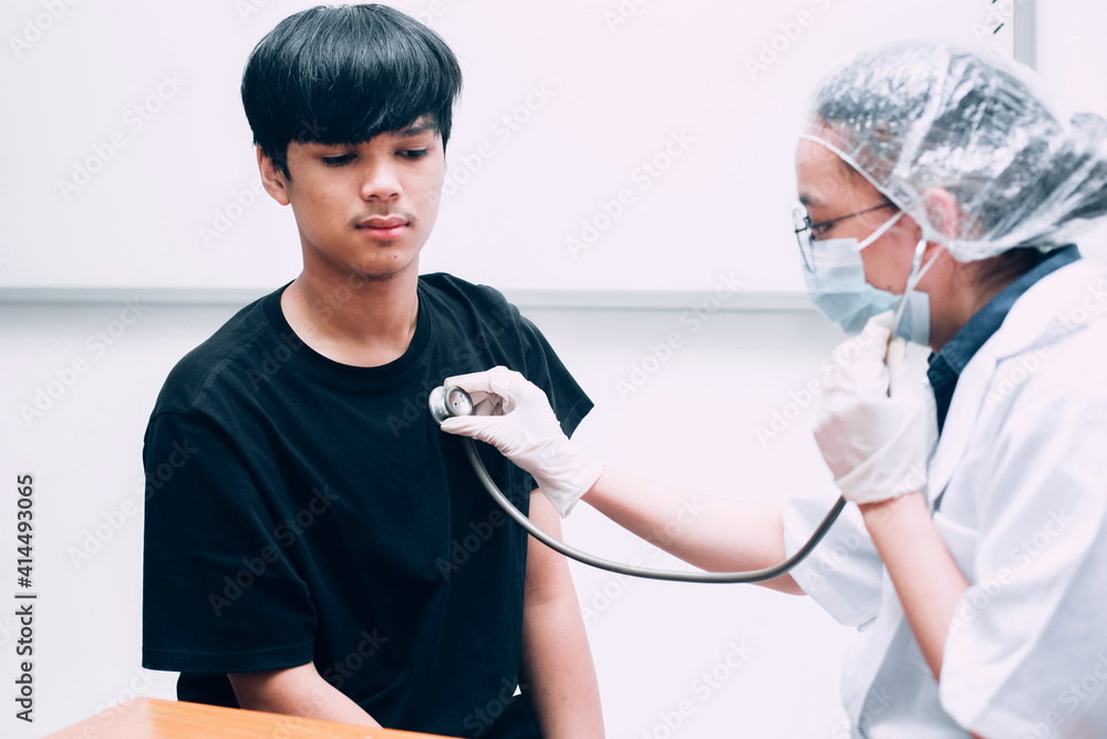 Doctor with stethoscope checking chest of guy at the hospital. Doctor with stethoscope checking chest of guy at the hospital.