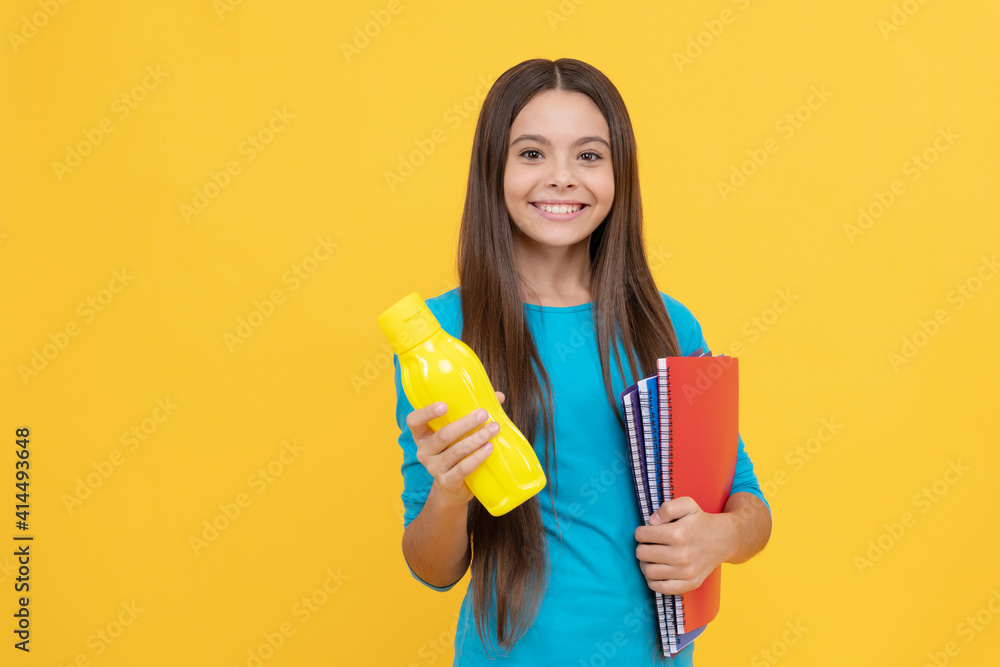 happy childhood. cheerful kid with juice or water and books. smiling teenager student. happy childhood. cheerful kid with juice or water and books. smiling teenager student.